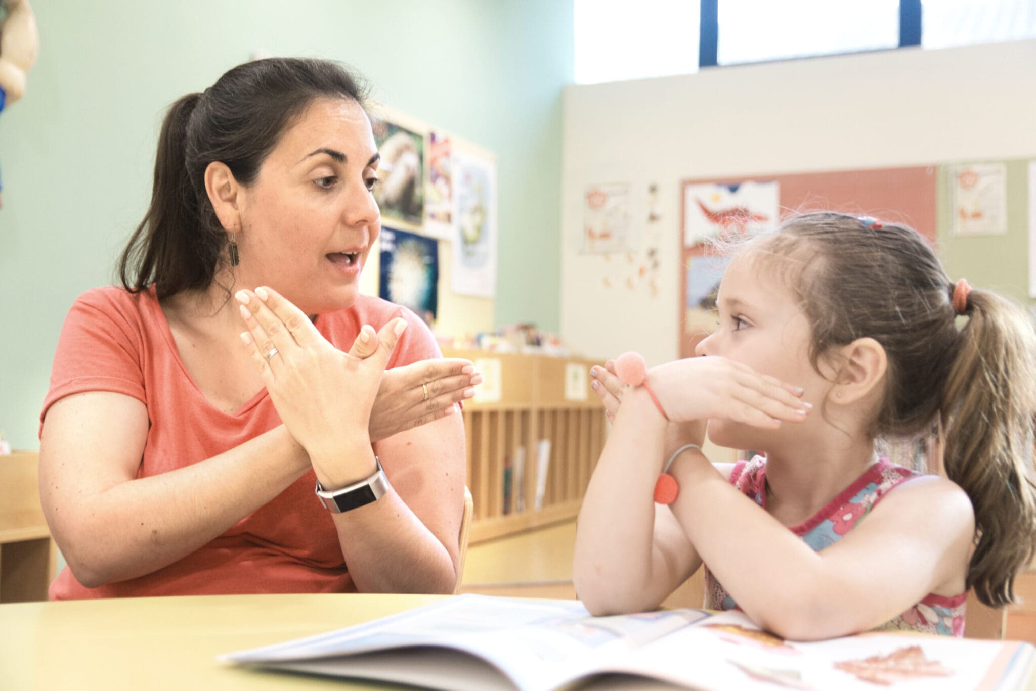 Sign language teacher in a extra tutoring class with a deaf chil